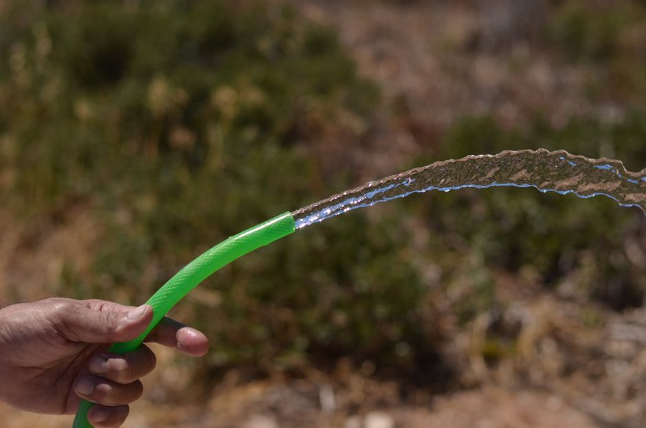 High-pressure water stream from a hose, representing hydro jetting drain cleaning services in Turlock, CA