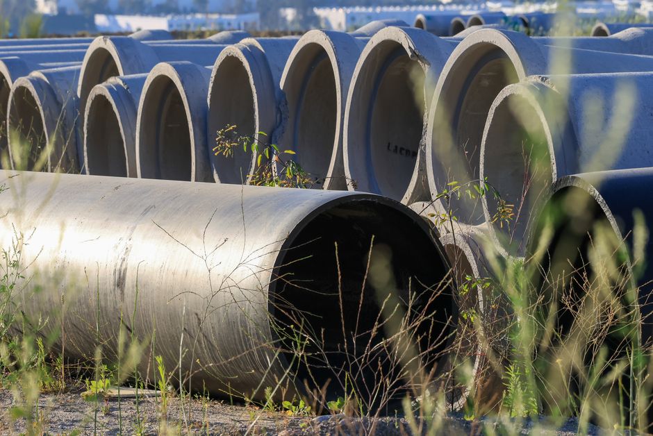 Large concrete sewer pipes stacked outdoors, ready for sewer line repair or replacement in Stockton, CA.