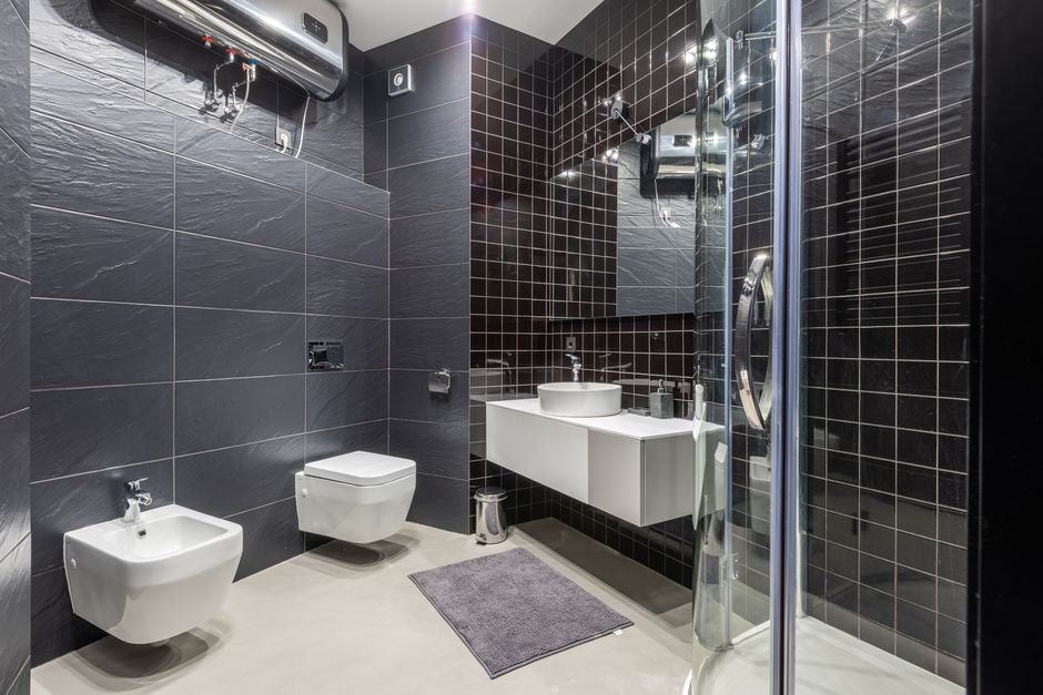 Wall-mounted tankless water heater installed in a modern bathroom, representing water heater installation services in Turlock, CA